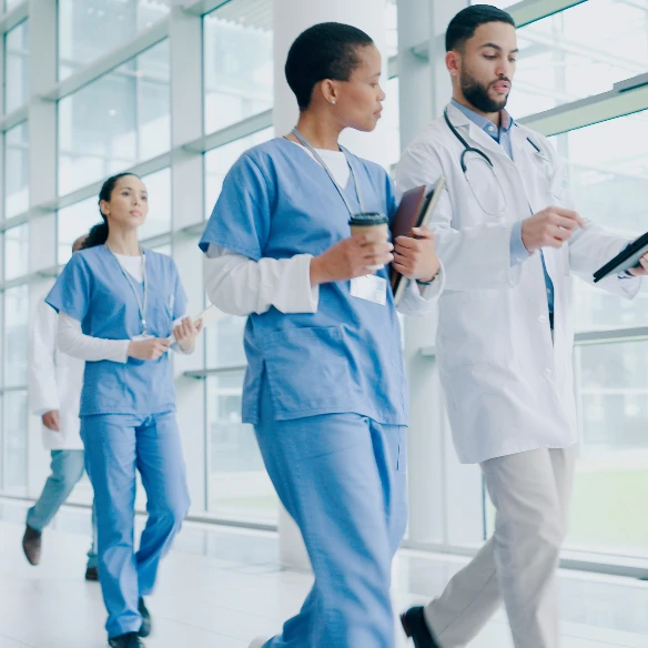 Clinicians and research staff walking through a hospital atrium